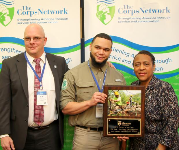 2019 Corps Network Project of the Year. Geoff Hamilton, Eduardo Gil, and Marie Walker, Chief Operating Officer of The Corps Network.